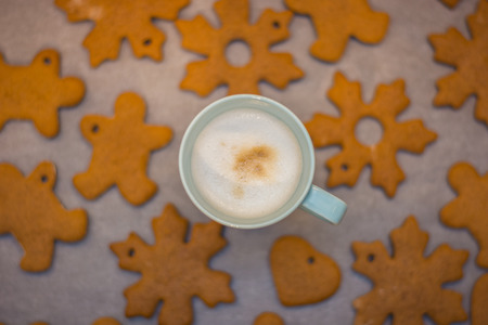 Cappuccino cup and home-made gingerbread in the backgroundの写真素材