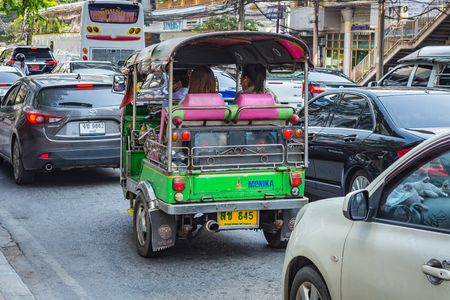 BANGKOK, THAILAND - NOVEMBER 2018: Auto rickshaw (tuk-tuk) with passengers on the sunny day in Bangkok, Thailandのeditorial素材