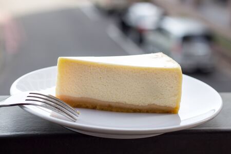 Cheesecake. Slice of Plain New York Cheesecake on white plate