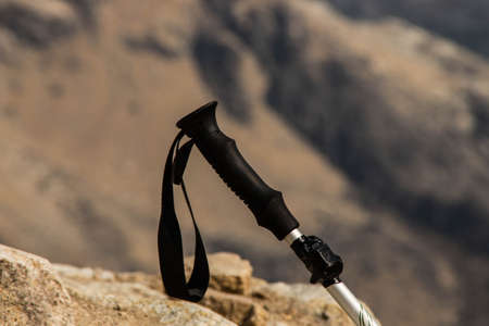 Trekking pole for hiking with the mountains in the background. Plastic and aluminum handleの写真素材