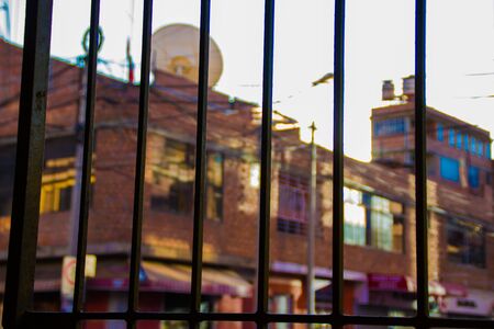 Iron grating and street background with houses