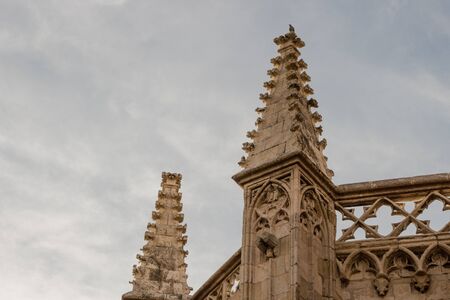 Pinnacle or towers of an old church with a pigeon on topの写真素材