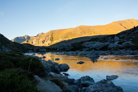 Lake in the mountain with beautiful reflections. With a water dam