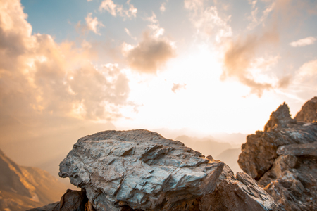 Sunset between rocks and clouds in the mountain. Very beautiful mountain sceneryの写真素材