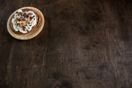 Pancake with cream and nuts. Close-up photo detail. Healthy and delicious breakfastの写真素材