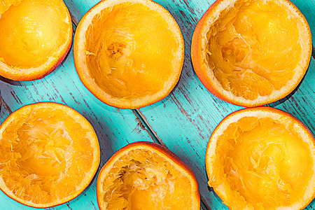 Oranges squeezed on a rustic blue background