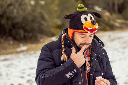 Young boy smiling in a funny hat. Photo taken in nature