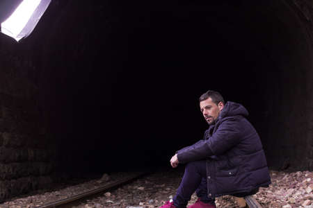 Sexy man on the train tracks, casual dressの写真素材