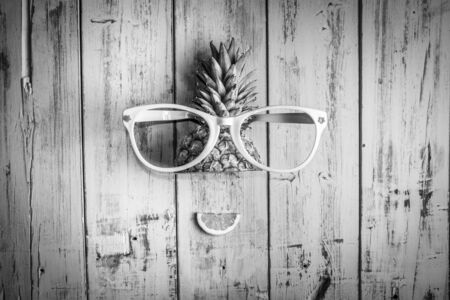 Pineapple with sunglasses, photo with warm and vivid colorsの写真素材