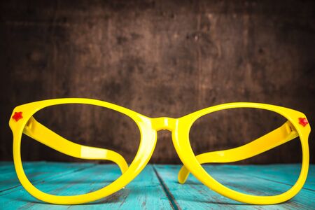 Yellow glasses on a blue background. Beach concept