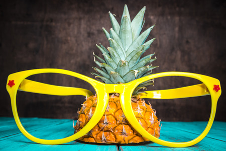 Pineapple with yellow sunglasses. Fun concept