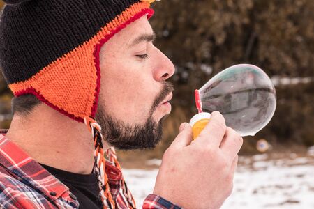 Playing with soap bubbles. Man in a funny hatの写真素材