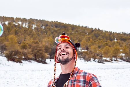 Playing with soap bubbles. Man in a funny hatの写真素材