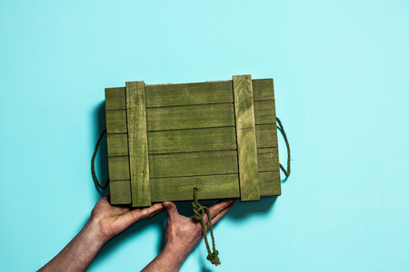 A rustic wooden box. Blue background and green box.の写真素材