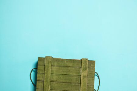 A rustic wooden box. Blue background and green box.の写真素材