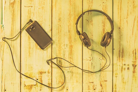 Music headphones attached to a mobile phone. Technology concept and current technologyの写真素材