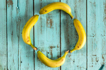 Bananas on a rustic blue wooden table. Healthy foodの写真素材
