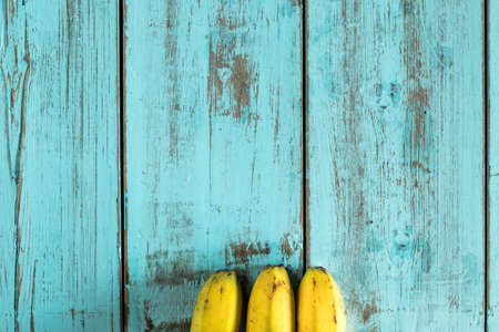 Bananas on a rustic blue wooden table. Healthy foodの写真素材