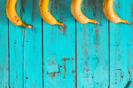 Bananas on a rustic blue wooden table. Healthy foodの写真素材