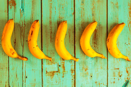 Bananas on a rustic blue wooden table. Healthy foodの写真素材