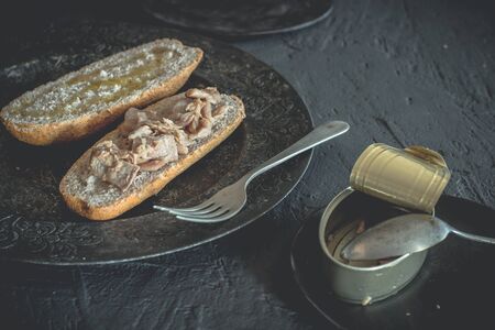 Tuna sandwich with whole wheat bread, healthy food, black food, on a rustic background.の写真素材