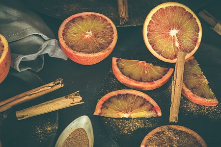 Blood oranges, on dark and rustic background. Dark foodの写真素材