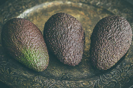 Whole avocados, on dark grey backgroundの写真素材