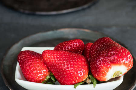 Strawberries on a plate. Grey and rustic backgroundの写真素材