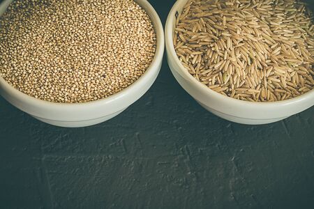 Wild raw brown rice and raw quinoa in a bowl. Healthy whole food. Perfect food for a diet