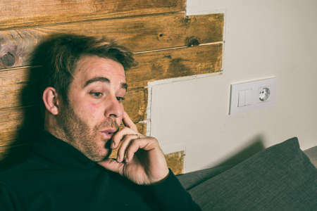 A normal man with a face is surprised. Portrait at home