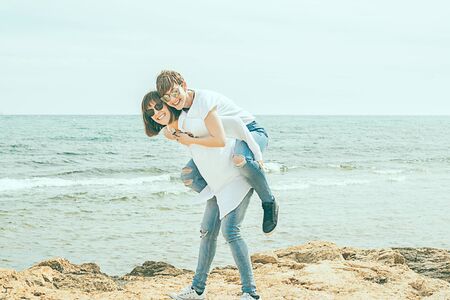 Two young women having fun on the beach. Concept of funの写真素材