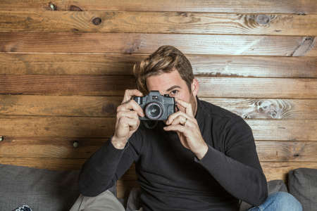 Normal young guy with a retro camera. Vintage style photography