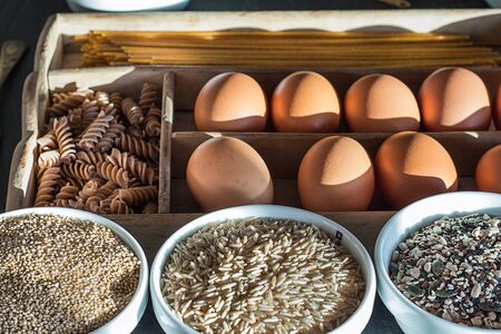 Whole-grain pasta and whole grains . Healthy food set with eggs and whole grains , rice, quinoa, oats, seeds, kamut and spaghettiの写真素材
