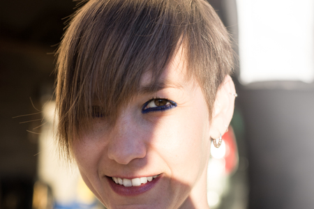 Sexy woman with short hair smiling. Close-up of a smiling girlの写真素材