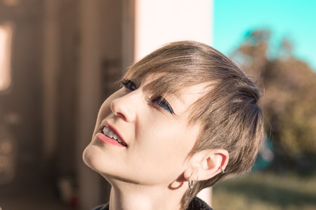 Sexy woman with short hair smiling. Close-up of a smiling girlの写真素材