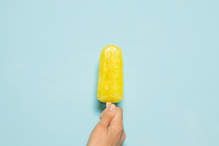 Lemon ice cream popsicle on blue backgroundの写真素材