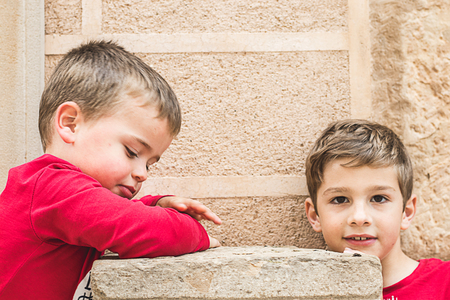 Portrait of two small blond children in the streetの写真素材