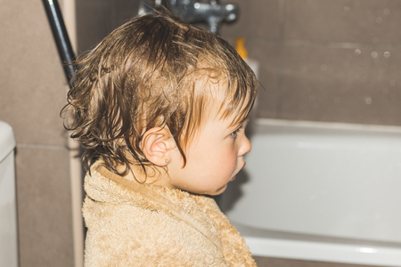 Freshly showered little girl. Little girl in the showerの写真素材