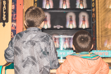 Children in a video game recreation center. Playing games