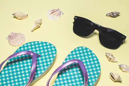 Summer items, flip-flops, sunglasses, hat. Summer concept, minimalist photo