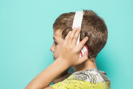 Kid with music helmets. Child with music headphonesの写真素材