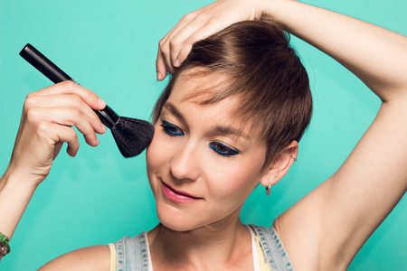 Girl applying makeup.Makeup conceptの写真素材