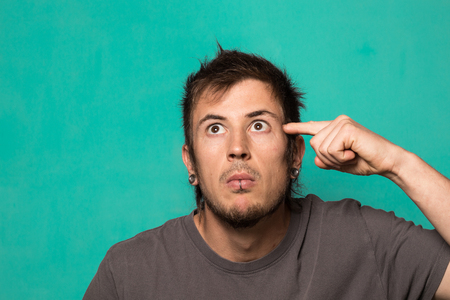A modern bearded guy making a funny expression. Man with funny facesの写真素材