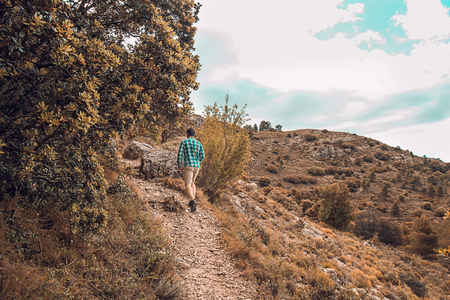 Man walking on the mountain. Guy practicing trekkingの写真素材