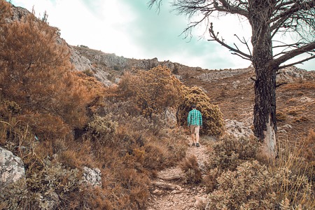 Man walking on the mountain. Guy practicing trekkingの写真素材