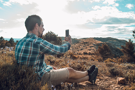Man making a selfie in the mountains.Guy mountaineerの写真素材