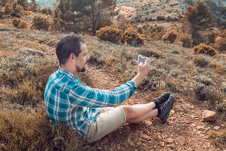 Man making a selfie in the mountains.Guy mountaineerの写真素材