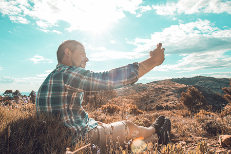 Man making a selfie in the mountains.Guy mountaineerの写真素材