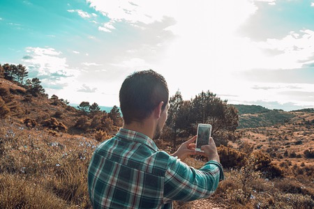 Man making a selfie in the mountains.Guy mountaineerの写真素材