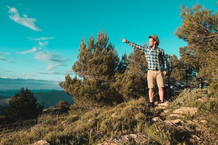 A man with a positive attitude in the mountains. Man dressed casual on the mountain